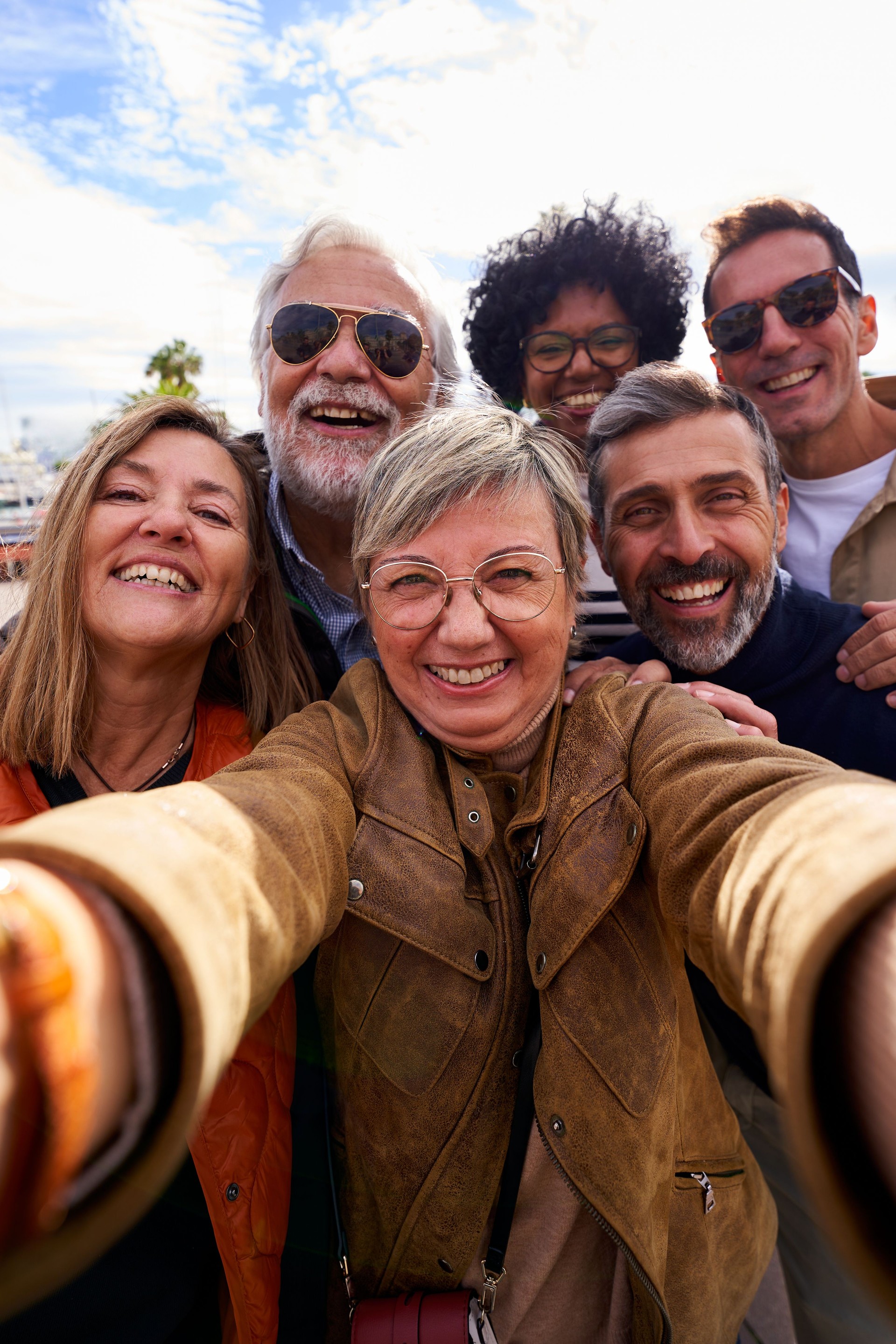 Multiracial group of mature people taking a selfie together.